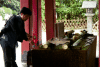 Norio showing me how to use the fountain, in a big temple place, near Kamakura station, I don't remember the name...